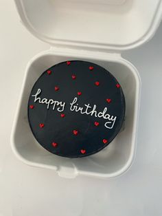 a happy birthday cake in a plastic container