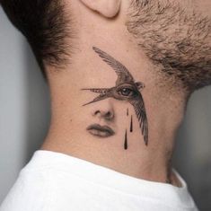 a man with a tattoo on his neck has a bird flying over his face and eyes