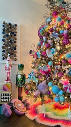 a brightly colored christmas tree with lots of ornaments