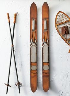 two wooden skis are hanging on the wall next to other items that have been made from wood