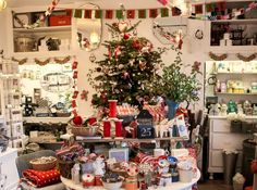 a room filled with lots of christmas decorations and gifts on top of a white table