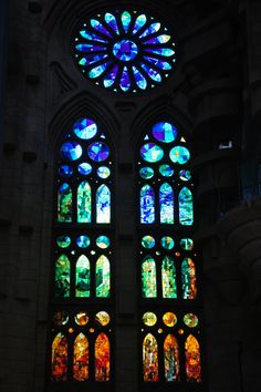 two large stained glass windows in a building with many different colors and shapes on them