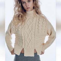 Cable Knit Pompom Sweater With High Color And Front Slits. Ecru Color Zara Winter White Sweater For Winter, Off White Open Knit Sweater For Fall, Winter White Open Knit Sweater, Zara Cable Knit Sweater For Winter, Beige Pointelle Knit Outerwear For Winter, Chic Beige Cable Knit Sweater, Chic Cream Open Knit Outerwear, Beige Knitted Outerwear By Zara, Beige Knitted Zara Outerwear