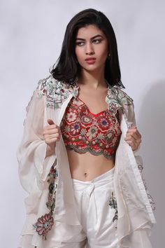 Ivory white floral embroidered jacket. Paired with an inner and embroidered pant.
Components: 3
Pattern: Embroidered
Type Of Work: Chikankari
Neckline: V Neck
Sleeve Type: Flared
Fabric: 25% Silk, 75% Cotton
Color: Ivory,White
Other Details: 
Attached cotton lining
Model Height: 5 ft 7 inches, wearing size M
Closure: Zip
Occasion: Resort - Aza Fashions White Tops With Dupatta For Festive Occasions, Red Chikankari Embroidery Sets For Spring, Spring Red Chikankari Embroidered Sets, Traditional Front Open Choli With Intricate Embroidery, Red Spring Festival Dupatta, Designer Spring Choli With Floral Embroidery, Spring Choli With Sheer Dupatta, Bohemian Off White Sets With Intricate Embroidery, Bohemian Off-white Sets With Intricate Embroidery