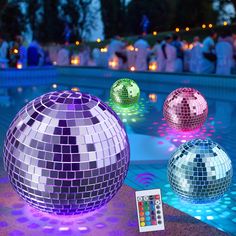 disco balls and remotes on the ground near a pool