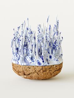 a blue and white vase sitting on top of a cork