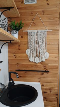 a bathroom with wooden walls and a black sink