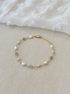 Please review the bracelet sizing guide below for the perfect fit! BALBOA PEARL BRACELET This pastel mixed Pearl and gem bracelet makes a beautiful addition to any bracelet stack! Each bead is hand wrapped in 14K Gold Filled or 925 Sterling Silver. The natural Aventurine gemstones are a mix of smooth and sparkly stones. * 4 mm natural Green Aventurine * 5-7 mm pink and white Pearls * 14K Gold Filled or 925 Sterling Silver accents * 14/20 GF for authenticity * Adjustable fit: 6.75" with 1" extend