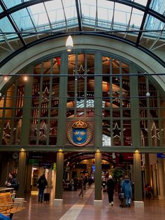 the inside of a building with people walking around