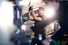 a man in black shirt working on a machine