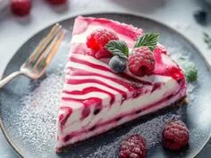 a piece of cheesecake with raspberries on top