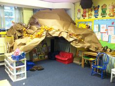 a room with chairs, desks and a tent in the middle that is made out of paper