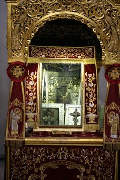 an ornate gold and red altar with paintings on it