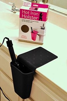 a hair dryer sitting on top of a counter next to a box of hair