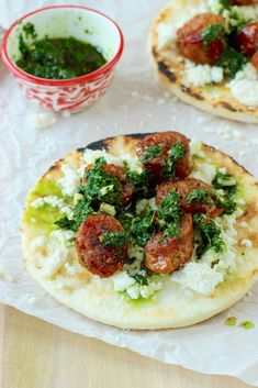 two pita breads with meat and veggies on them