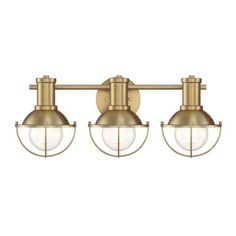 three light brass finish bathroom fixture with clear glass globes on the front and sides