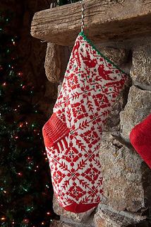 a red and white christmas stocking hanging from a fireplace