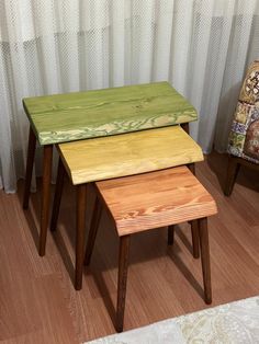 three wooden stools sitting next to each other on top of a hard wood floor