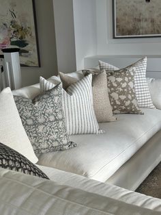 a white couch with many pillows on it