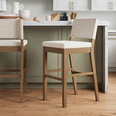 two stools sitting in front of a kitchen counter