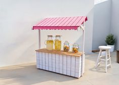 a small bar with jars and lemonade on it