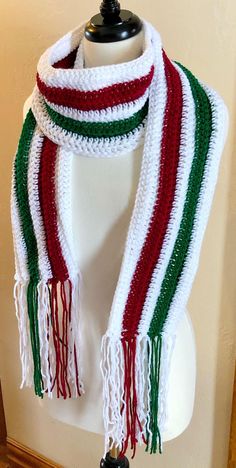 a white, red and green scarf on a mannequin