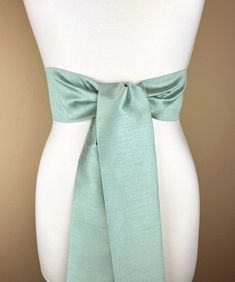 Wide Textured Seafoam Green Sash  Pastel Green Dupioni Sash  Light Green Dress Sash  Dupioni Belt  Green Wedding Dress Sash  Add sophistication and rich texture to your special occasion outfit with this Satin Swank® dupioni waist sash. Depending on your waist size and the length you choose (75 and 90 inch lengths available), you can wrap this sash around your waist once or twice. You decide whether to tie the sash in a bow or a simple knot with long-hanging tails. Tie in front, in back, or on the side. A double layer of dupioni fabric in seafoam green. Sash is the same front and back, seams are hidden within the fold lines, and ends are finished on the angle. Dupioni features a rustic weave with naturally occurring slubs and tiny thread loops running throughout the fabric resulting in exqu Green Wedding Dress, Green Sash, Light Green Dress, Green Wedding Dresses, Evening Wear Dresses, Occasion Outfit, Plus Size Belts, Wedding Dress Sash, Formal Evening Wear