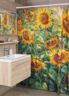 a bathroom with a sunflower shower curtain next to a sink