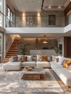 a large living room with white couches and stairs