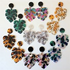 a group of different types of earrings on a white surface with black circles around them