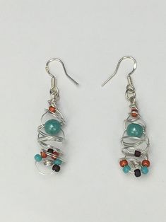 These earrings were fun to make.  I started off with non tarnish silver wire and started to coil a variety of colored beads into it to create a pair of earrings that can be worn with any outfit! 2" in Length. **All my jewelry comes packaged  in a nice Gift Box. Silver Earrings With Colorful Beads, Unique Silver Wire Wrapped Beaded Earrings, Distinctive Silver Wire Wrapped Beaded Earrings, Silver Wire Wrapped Beaded Earrings, Handmade Silver Wire Wrap Earrings, Silver Beaded Earrings With Silver-plated Wire, Wire Wrapped Round Bead Metal Earrings, Adjustable Nickel-free Silver Plated Wire Wrap Earrings, Wire Wrapped Spiral Earrings In Silver Plated Wire