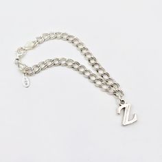 A solid letter "Z" charm marked "925" hangs from a 7" double curb chain with lobster clasp marked "925 ITALY. (Measure wrist and add 1/2" to 1" for best bracelet fit. Made from vintage components that acid test as sterling silver. Weight is almost 9 grams. Silver Curb Chain Jewelry For Birthday, Sterling Silver Charm Bracelet With Initials In Silver, Sterling Silver Nickel-free Charm Bracelet For Birthday, Personalized Silver Link Chain Bracelet, Silver Metal Charm Bracelet With Curb Chain, Silver Initial Pendant With Curb Chain, Silver Birthday Charms With Lobster Clasp, Silver Hypoallergenic Link Charm Bracelet, Silver Charm Bracelet With Lobster Clasp For Birthday