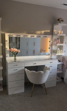 a bedroom with a desk, chair and mirror on it's wall next to a bed