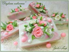 four soap bars decorated with pink roses and green leaves on top of a white surface