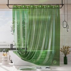 a bathroom with a green shower curtain next to a bathtub