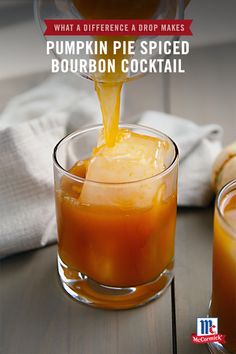 an orange drink being poured into a glass with the words what a difference drop makes pumpkin pie spiced bourbon cocktail