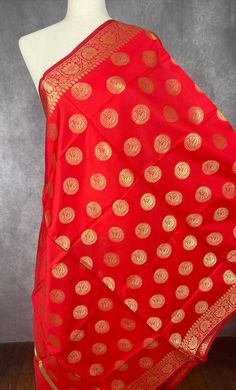 Gorgeous Bright Red Banarasi Dupatta. Dupatta is Soft and will add beauty to any Outfit. Makes a Perfect Gift! PLEASE NOTE - TASSLES AT THE ENDS OF THE DUPATTA ARE red IN COLOR. Item: DupattaColor : Bright RedFabric : Banarasi Silk (Non Pure Silk)Work : Zari Weaved with tassels Length of the dupatta : 35 inches (approx)Width of the dupatta : 92 inches (approx)Store Policies- No return or exchange will be accepted for color variations.- No return or exchange will be accepted if the color does not Red Dupatta With Pallu For Traditional Ceremonies, Traditional Red Art Silk Dupatta, Festive Red Dupatta For Navratri, Red Traditional Festive Dupatta, Red Traditional Wear With Dupatta For Celebration, Red Dupatta With Traditional Patterns, Red Art Silk Dupatta For Puja, Red Art Silk Dupatta For Diwali, Unstitched Red Traditional Wear For Festivals