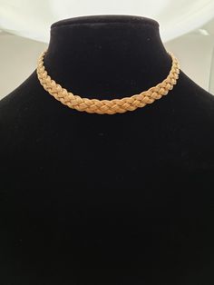 This vintage 14k gold woven choker is a standout piece, discovered at a vintage estate sale and crafted with both boldness and elegance in mind. Weighing 28.9 grams, it features an intricate braided design that not only adds texture but also beautifully captures and reflects the light, giving it a dynamic, shimmering appearance. Measuring 15 inches long (excluding the clasp) and 9.2 mm wide, it makes a statement while remaining versatile for various occasions. The choker is secured with a textured box clasp, hallmarked with interlocking circles containing the letters "D," "F," and "S." This is a beautiful piece for lovers of vintage jewelry and anyone seeking a unique, one-of-a-kind necklace. Item Details: Metal: 14k Gold (Hallmarked) Weight: 28.9 grams Length: 15 inches (not including the Woven Choker, D F, Box Clasp, Fine Jewellery Necklace, Estate Sale, Favorite Jewelry, Jewelry Necklace Pendant, Choker Necklace, Jewelry Watches