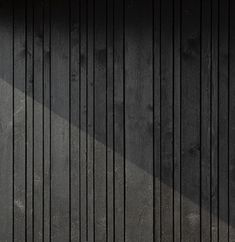 a person riding a skateboard on top of a wooden floor next to a wall