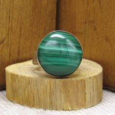 "Magnificent sterling silver large round malachite ring. This ring is a size 6 3/4. The round stone is 18mm. It is set in a plain bezel with no other embellishments. The band is a solid 5mm band with a lightly hammered texture. The band is hallmarked on the inside \"925\" and there is also a hallmark unrecognizable to me. A beautiful and simple ring that would certainly demand attention. Thank you for looking and please feel free to reach out with any questions. *The color you see on your screen Round Malachite Gemstone Jewelry, Malachite Round Gemstone Jewelry, Silver Round Malachite Jewelry, Spiritual Sterling Silver Round Emerald Ring, Spiritual Round Sterling Silver Emerald Ring, Sterling Silver Cabochon Emerald Ring, Malachite Gemstone Ring, Malachite Rings Suitable For Gifts, Malachite Rings As Gifts