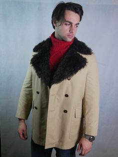 This 1970s European vintage double-breasted coat is beige with a super-wide brown faux fur collar. The coat has two pockets on the front and closes with three buttons (six in total show on the front). The cotton-blend coat has a quilted upper-back lining and a faux shearling lower-back lining.Condition: Excellent (Professionally Cleaned ... soft and supple, with no stains, tears, wear spots, or weaknesses in the seams) Brand label: Stoffels (Germany) Size: 40 US/UK Material: 67% Tetrylene Polyes Beige Jacket, Vintage Clothing Men, Brand Label, European Vintage, Double Breasted Coat, 70s Vintage, Vintage Coat, Faux Fur Collar, Fur Collar