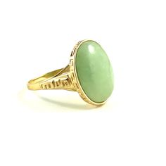 Unique light apple green jade ring Material: 14 karat yellow gold Gems: one oval cabochon Jadeite measuring approx 16.5 x 12.5 mm and weighing approx 5.25 carats  Weight: 5.1 grams Ring size: 8 1/4 Measurements: the oval top measures approx 18 x 15 mm. The band is approx 4.5 mm wide on the shoulders and tapers to approx 1.7 mm at the bottom of the shank.  Note: The ring will be accompanied by the written appraisal certificate shown in the last paragraph Classic Green Oval Opal Ring, Green Oval Dome Ring For Formal Occasions, Green Opal Oval Ring In 14k Gold, Antique Gold Emerald Ring With Oval Cabochon, Antique Emerald Ring In Gold With Oval Cabochon, Classic Green Cabochon Ring, Heirloom Green Oval Cabochon Rings, Oval Jade Rings Hallmarked, Yellow Gold Jade Cabochon Ring