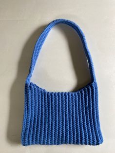 This is a blue crocheted shoulder bag. It is made using the single crochet stitch and will not stretch out over time. It is a perfect addition to any outfit. Cheap Handmade Blue Crochet Bag, Blue Knitted Shoulder Bag For Daily Use, Blue Knitted Shoulder Bag For Everyday, Trendy Blue Crochet Tote Bag, Trendy Blue Crochet Bags, Casual Blue Knitted Shoulder Bag, Trendy Blue Crochet Bag For Everyday Use, Trendy Blue Crochet Bag For Everyday, Blue Crochet Shoulder Bag For Everyday