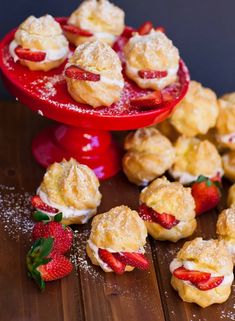 strawberry shortcakes with powdered sugar and fresh strawberries on a red plate