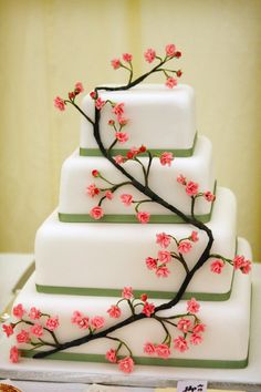 a three tiered cake with pink flowers on it