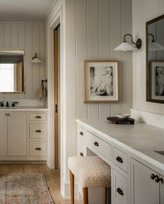 a bathroom with white walls and wooden floors