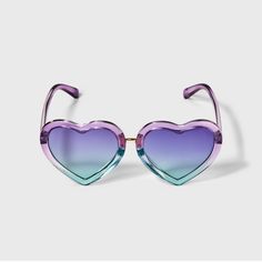 The Girls' Heart Sunglasses by Cat & Jack™ are not only stylish but also make for a functional, essential accessory to add to your collection. Made from recycled plastic, the heart-shaped purple and blue frame adds a pop of vibrant color to your look. The blue lens provides maximum UV protection with a gradient lens feature, making these glasses perfect for any outdoor activity. Cat & Jack™: Kids’ clothing with an imagination of its own. Playful Heart-shaped Sunglasses With Uv Protection, Playful Heart-shaped Sunglasses With Gradient Lenses, Purple Tinted Fun Sunglasses, Fun Purple Tinted Sunglasses, Multicolor Heart-shaped Sunglasses With Gradient Lenses, Heart-shaped Multicolor Sunglasses With Gradient Lenses, Trendy Multicolor Heart-shaped Sunglasses, Pride Products, Girls Heart