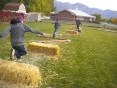 children playing in the yard with hay bales