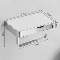 an image of a bathroom tissue dispenser on the wall with measurements for it