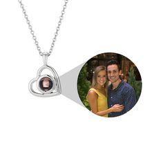 a couple's photo is shown in the shape of a heart on a necklace